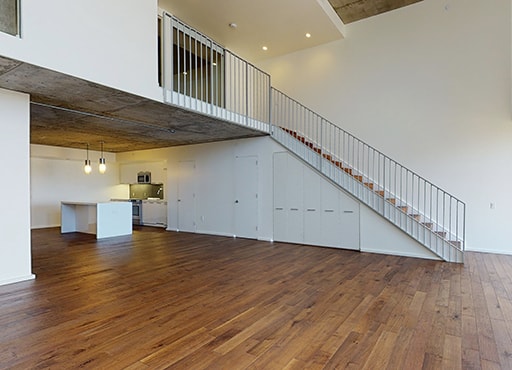 Unfurnished bi-floor townhouse with a staircase leading up