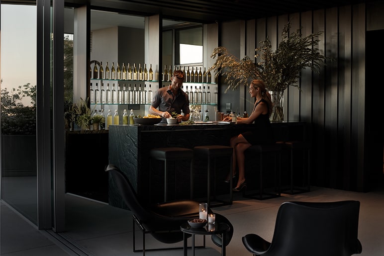 Woman at a Rooftop Lounge bar being served a drink