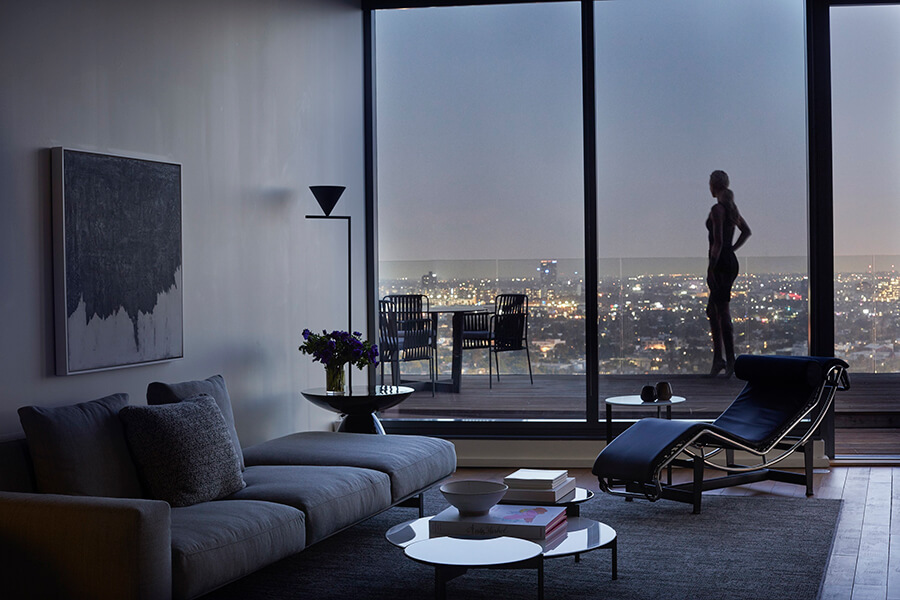 AKA West Hollywood living room dusk with woman standing by the window