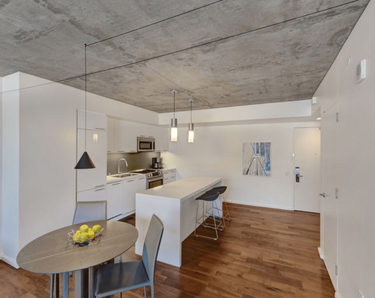 WeHo kitchen with white cabinets and a dining table